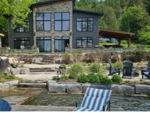 Conestoga Lake cottage with armor stone retaining, flagstone fire pit, hot tub, sitting area, and more
